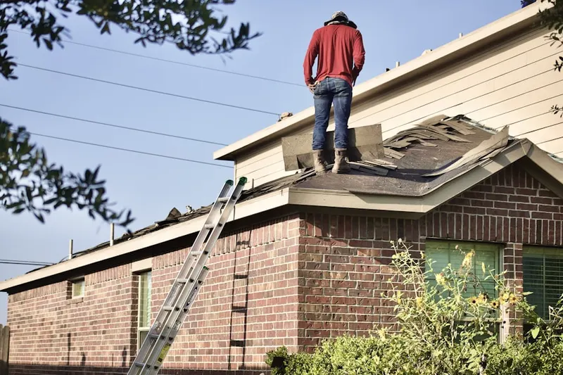 Professional roofer working on a residential roof in Happy Corners